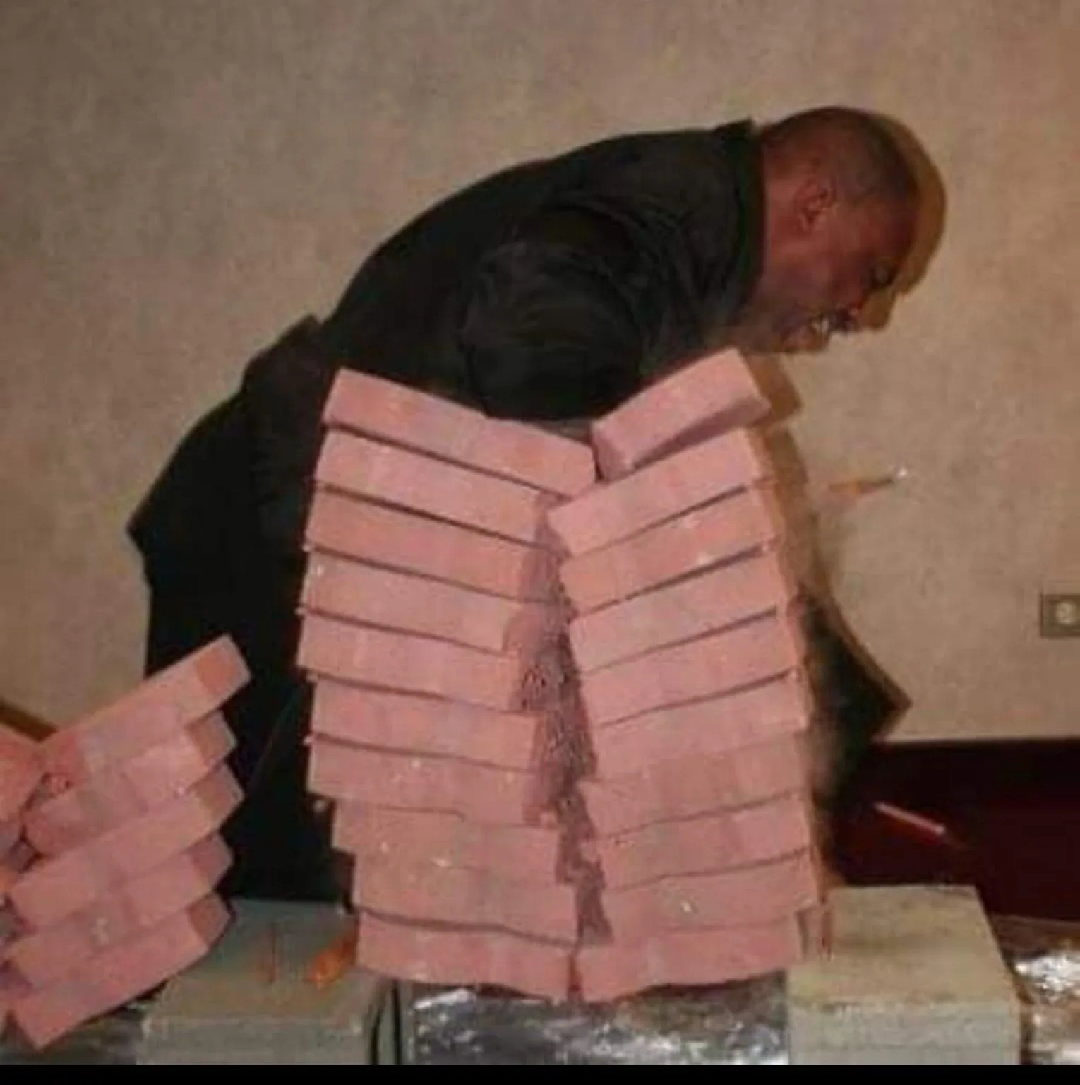 Historical photograph of Fred Jordan demonstrating a brick-breaking martial arts technique